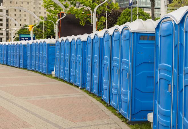 a row of portable restrooms set up for a large athletic event, allowing participants and spectators to easily take care of their needs in Edgemere